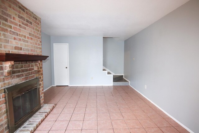 8720 Glen Mdw, Beaumont, TX 77706 - unfurnished living room with stairway, a fireplace, light tile patterned floors, and baseboards