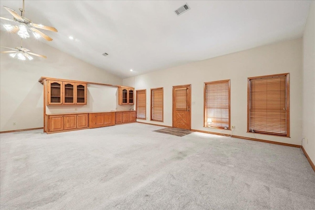 7385 Fannett Rd, Beaumont, TX 77705 - unfurnished living room with a ceiling fan, baseboards, light carpet, and high vaulted ceiling
