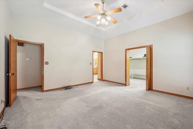 7385 Fannett Rd, Beaumont, TX 77705 - spare room featuring light colored carpet, ceiling fan, baseboards, a high ceiling, and a tray ceiling