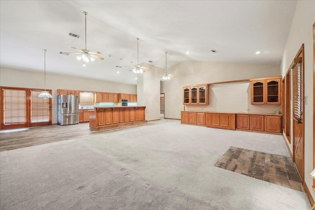 7385 Fannett Rd, Beaumont, TX 77705 - unfurnished living room with light colored carpet, ceiling fan, and high vaulted ceiling