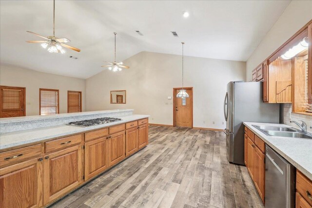 7385 Fannett Rd, Beaumont, TX 77705 - kitchen with a sink, appliances with stainless steel finishes, light countertops, light wood-type flooring, and high vaulted ceiling