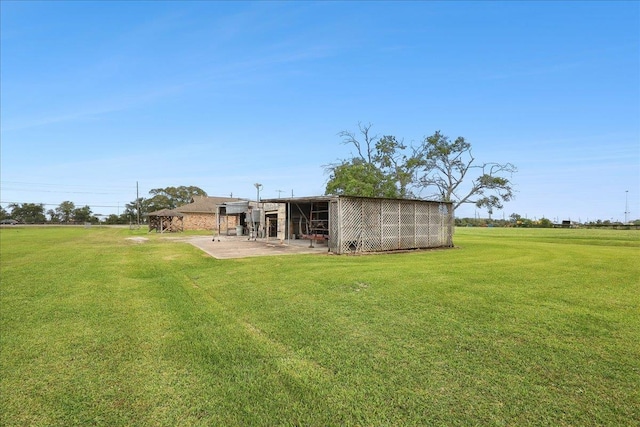 7385 Fannett Rd, Beaumont, TX 77705 - back of property featuring a lawn and an outbuilding