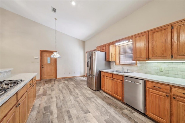 7385 Fannett Rd, Beaumont, TX 77705 - kitchen with stainless steel appliances, a sink, light countertops, decorative backsplash, and high vaulted ceiling