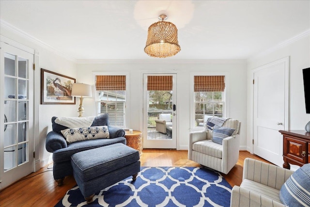 living area featuring wood finished floors and ornamental molding