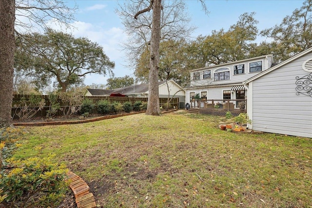 view of yard featuring a deck and fence