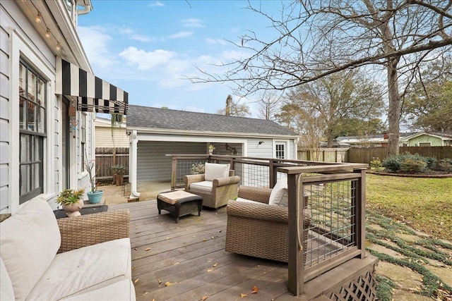 wooden terrace with outdoor lounge area and fence