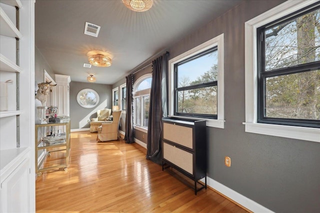 interior space with visible vents, baseboards, and light wood-style floors