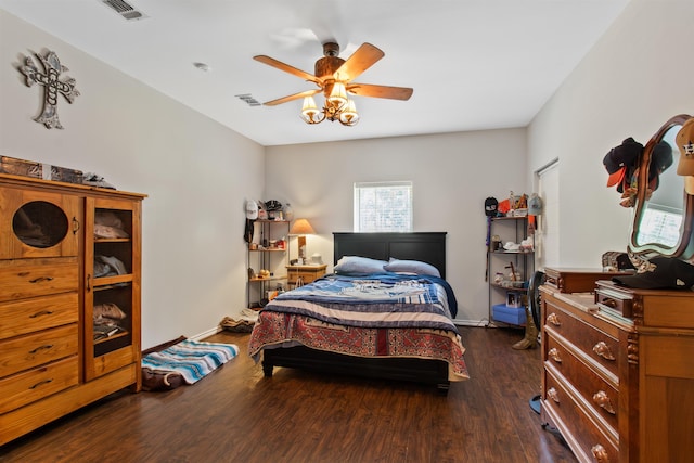 bedroom with dark hardwood / wood-style floors and ceiling fan