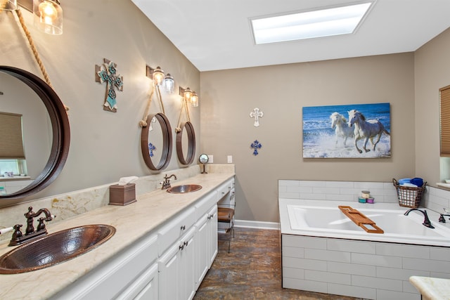 bathroom with tiled tub and vanity