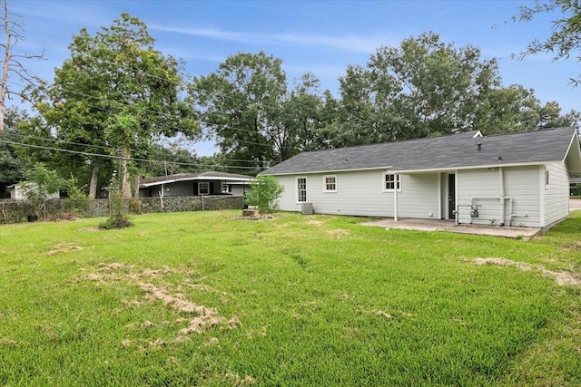 back of house with a patio area and a yard