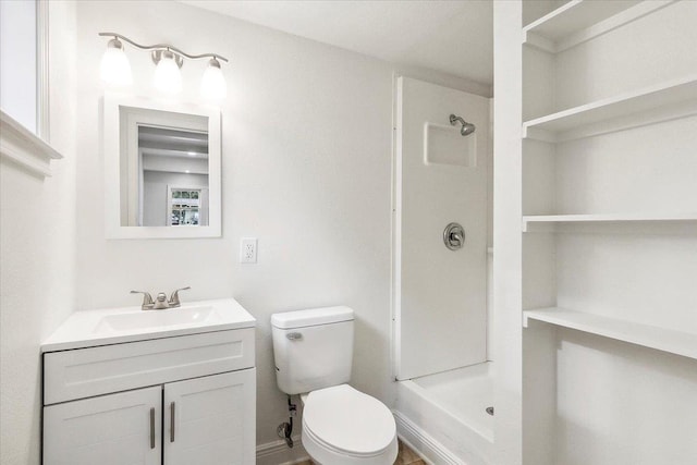 bathroom with vanity, toilet, and walk in shower