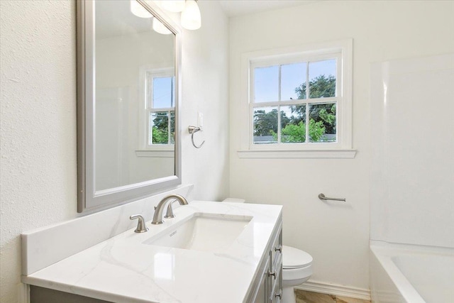 bathroom featuring vanity and toilet