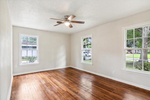 empty room with hardwood / wood-style floors, a textured ceiling, and ceiling fan