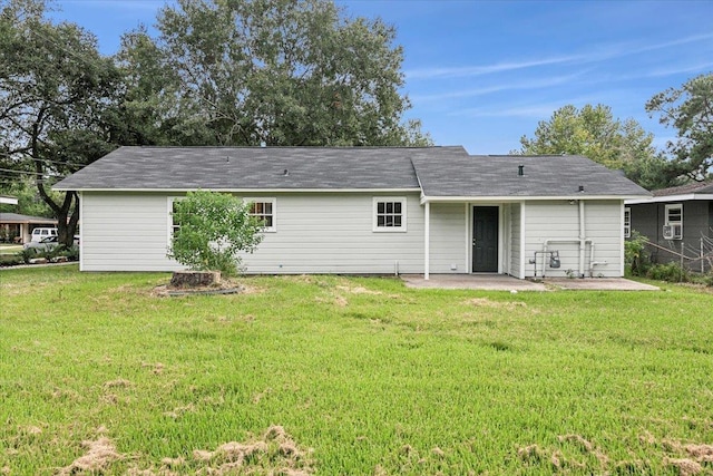 rear view of house with a yard and a patio