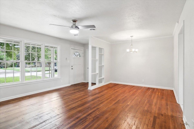 empty room featuring ceiling fan with notable chandelier, a textured ceiling, and dark hardwood / wood-style flooring