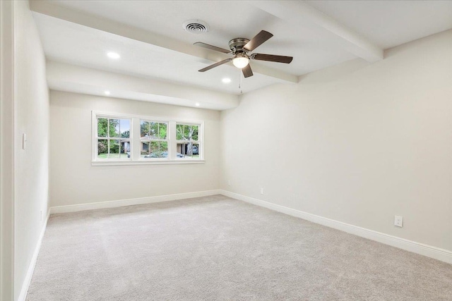 empty room with beamed ceiling, ceiling fan, and light colored carpet