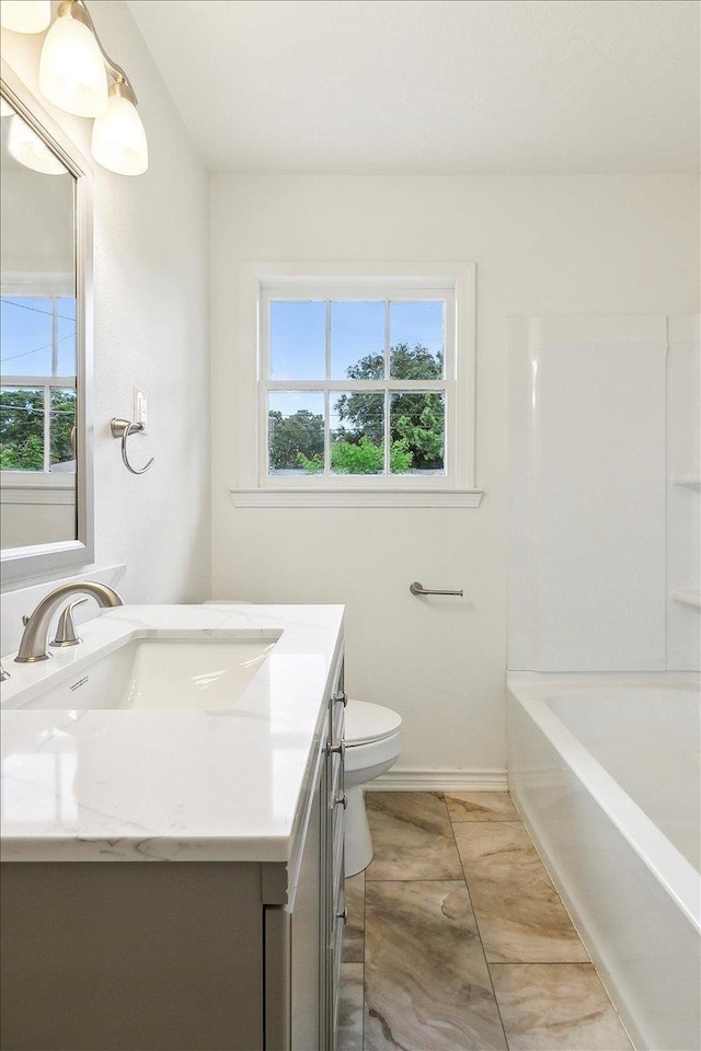 full bathroom featuring tile patterned floors, vanity, toilet, and plenty of natural light