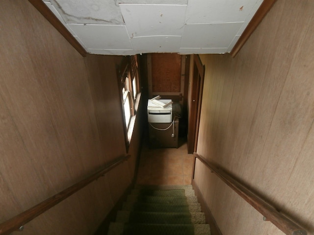 stairs featuring wooden walls