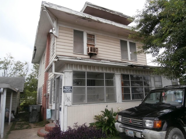 view of side of property with cooling unit