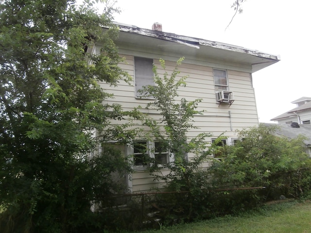 428 Augusta Ave, Port Arthur, TX 77640 - view of home's exterior with cooling unit and a chimney