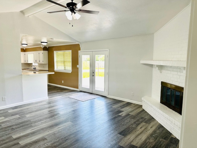 9130 Doty St, Beaumont, TX 77707 - unfurnished living room with ceiling fan, dark wood-style flooring, baseboards, a fireplace, and french doors