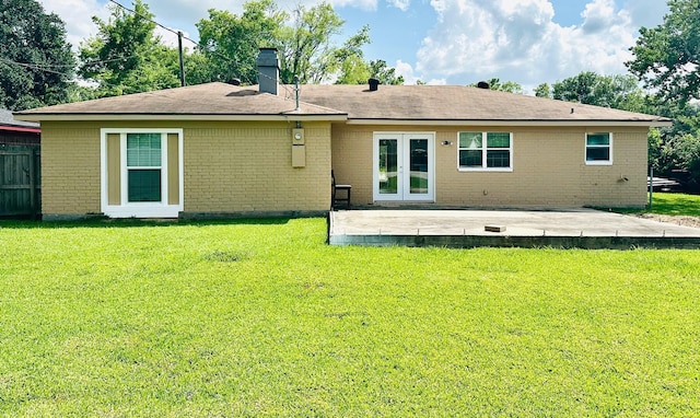 9130 Doty St, Beaumont, TX 77707 - rear view of property with a patio, brick siding, and a lawn