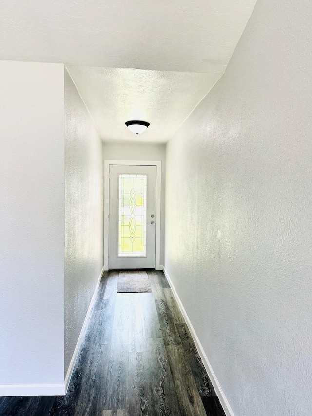 9130 Doty St, Beaumont, TX 77707 - doorway with wood finished floors, baseboards, and a textured wall