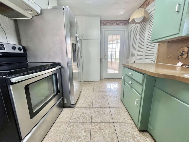 kitchen featuring light tile patterned floors, extractor fan, wooden counters, stainless steel range with electric stovetop, and green cabinetry