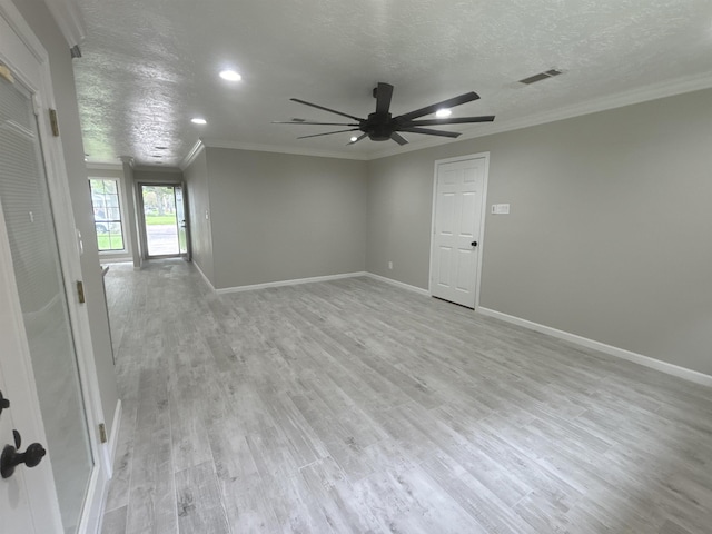 empty room featuring a textured ceiling, ceiling fan, crown molding, and light hardwood / wood-style flooring