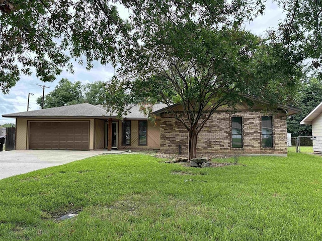 ranch-style home with a front lawn and a garage