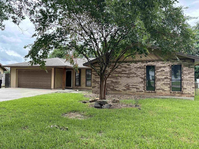 ranch-style house featuring a front yard and a garage