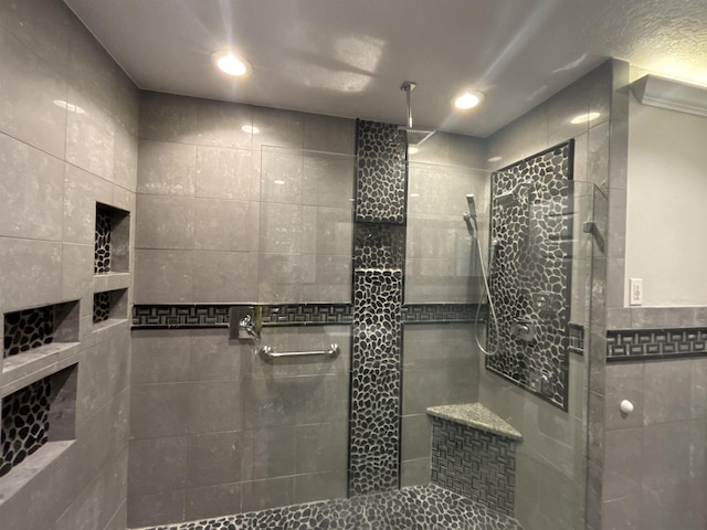 bathroom with tile walls and a tile shower