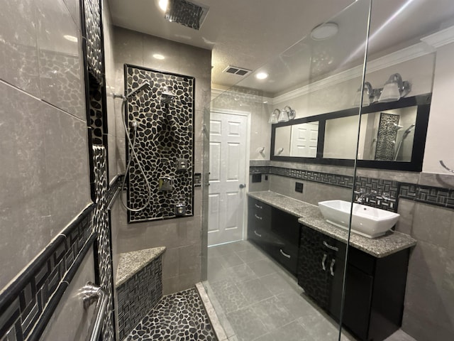 bathroom featuring tile walls, vanity, and tile patterned flooring