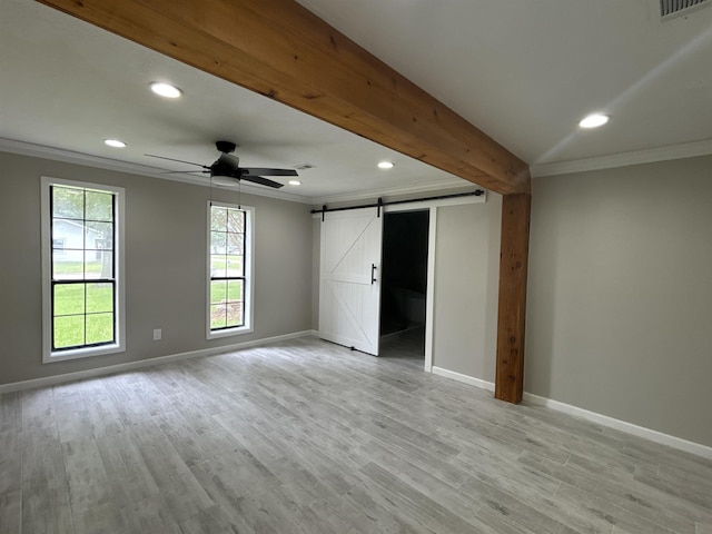 unfurnished bedroom featuring ceiling fan, a barn door, beam ceiling, crown molding, and light wood-type flooring