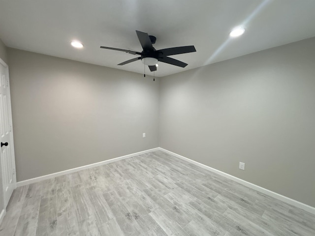 unfurnished room with ceiling fan and light hardwood / wood-style floors