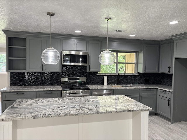 kitchen featuring sink, gray cabinets, and stainless steel appliances