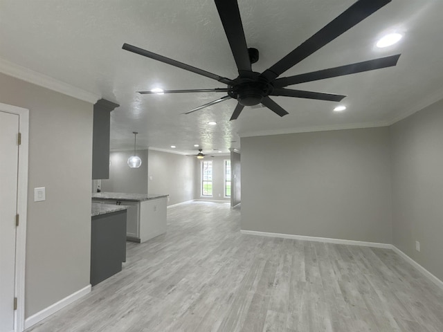 unfurnished living room featuring a textured ceiling, ceiling fan, ornamental molding, and light hardwood / wood-style flooring