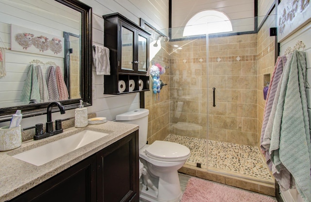 bathroom featuring vanity, toilet, and walk in shower