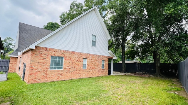 rear view of property with a lawn