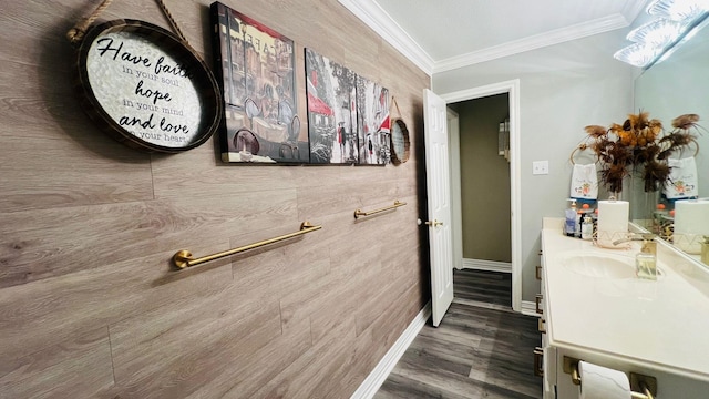 bathroom featuring vanity, wood-type flooring, and ornamental molding