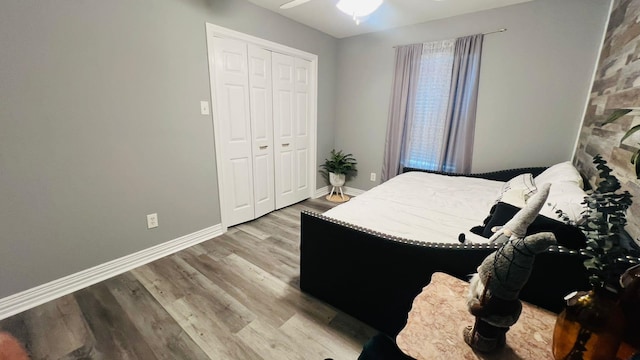 bedroom with ceiling fan, a closet, and light wood-type flooring