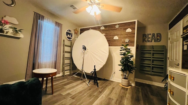 miscellaneous room with ceiling fan and hardwood / wood-style floors