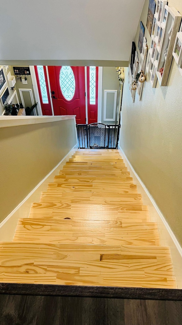 stairs with hardwood / wood-style floors