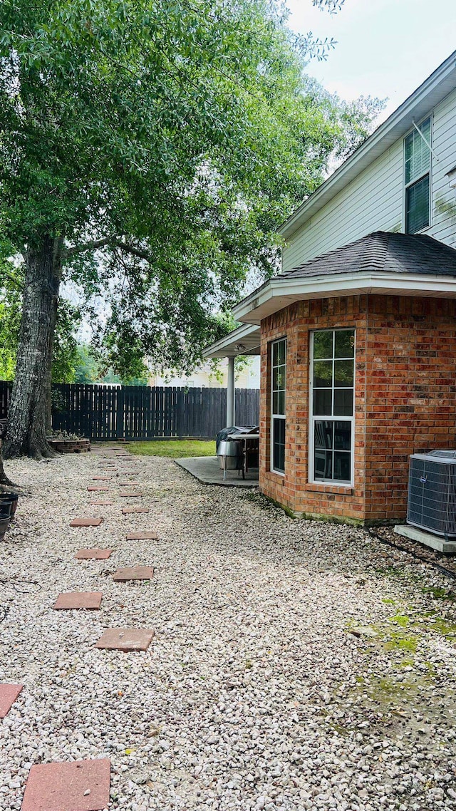 view of yard featuring central air condition unit and a patio area