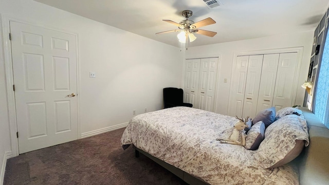 carpeted bedroom featuring ceiling fan and multiple closets