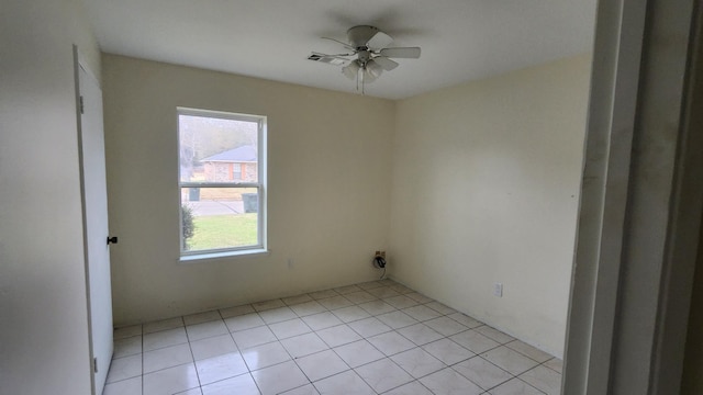 spare room with light tile patterned floors and ceiling fan