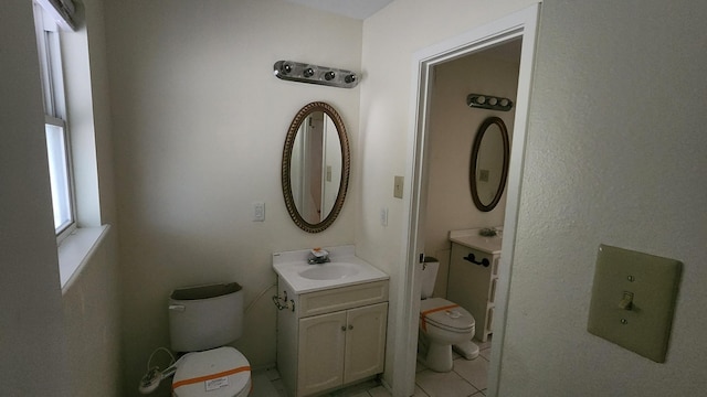 bathroom with vanity, tile patterned flooring, and toilet