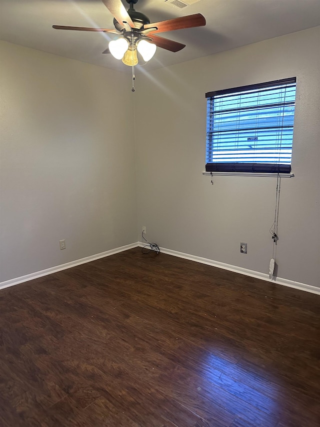 empty room with ceiling fan and dark wood-type flooring