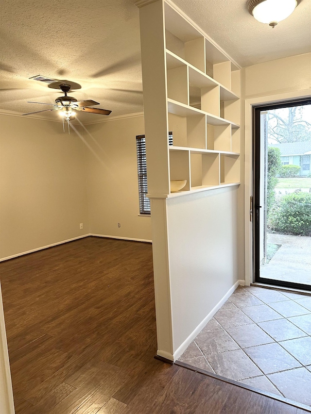 doorway to outside with hardwood / wood-style floors, a textured ceiling, and ceiling fan