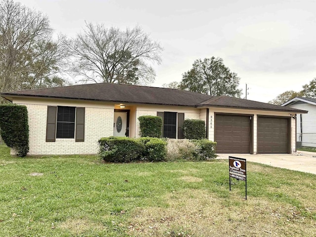 ranch-style home featuring a front yard and a garage